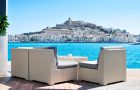 an empty couch at the Mediterranean Sea, with Sa Penya and Dalt Vila districts, the old town of Ibiza Town, in the background, in the Balearic Islands, Spain