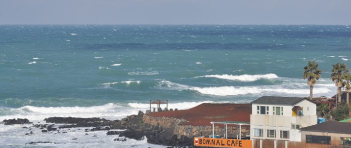 Jeju island, South korea - December 6th, 2013 : The guest house and cafe by seaside in Jeju island presents dynamic view depend on weather